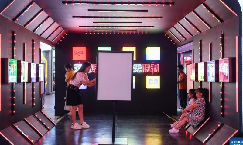 Children pose for photos at a local market at the Qingyun Road in Nanming District of Guiyang, capital city of southwest China's Guizhou Province, July 21, 2022. Photo: Xinhua
