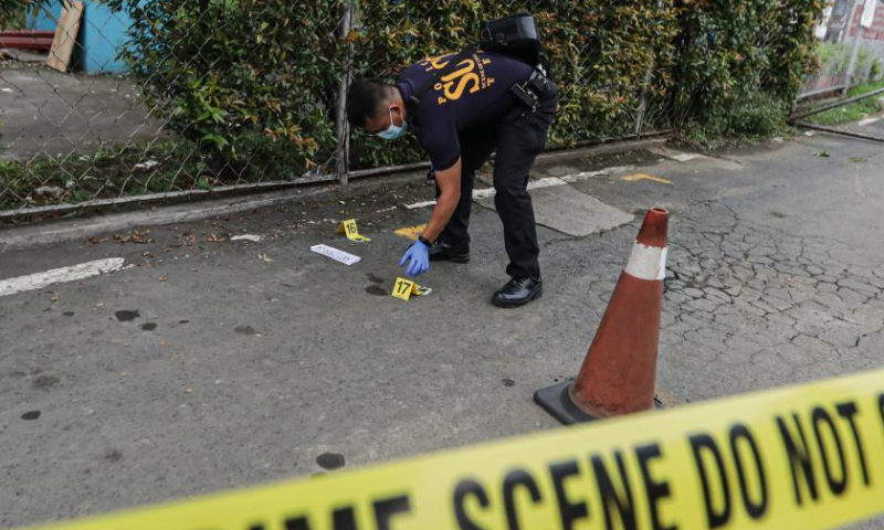 A member of the Philippine National Police inspects the site of a shooting incident at Ateneo de Manila University in Quezon City, the Philippines, July 24, 2022. Three people were killed and two others injured in a shooting incident Sunday afternoon on a university campus in Metro Manila, the Philippine police said. The arrested gunman has admitted to the killing with specific target. Photo: Xinhua