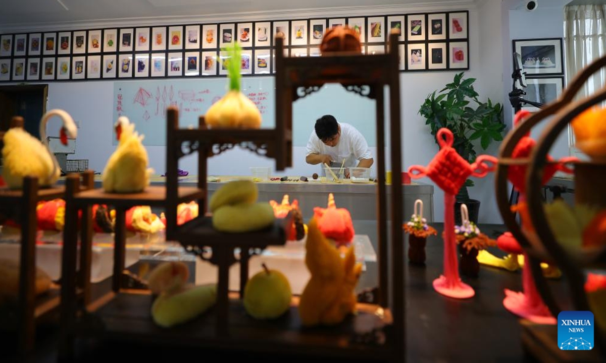 
Chef Wu Yang makes a pastry at his studio in Shenyang, capital of northeast China's Liaoning Province, July 14, 2022. Wu Yang, a 35-year-old chef, has made pastry for ten years. Inspired by traditional Chinese culture, he has created various pastries with vivid shapes at his studio. (Xinhua/Yang Qing)
