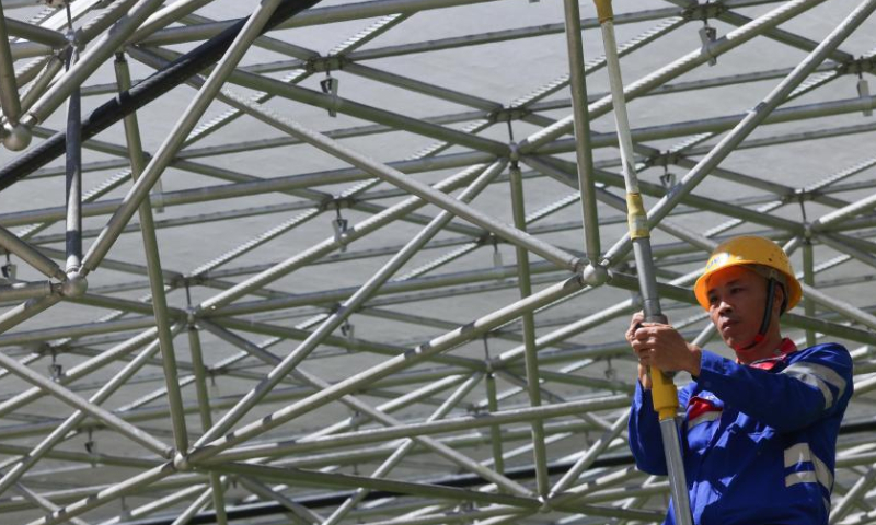 A staff member performs a regular maintenance operation on the Five-hundred-meter Aperture Spherical Radio Telescope (FAST) in southwest China's Guizhou Province on July 21, 2022 Using FAST, also dubbed as the China Sky Eye, scientists have identified over 660 new pulsars since October 2017. Photo: Xinhua