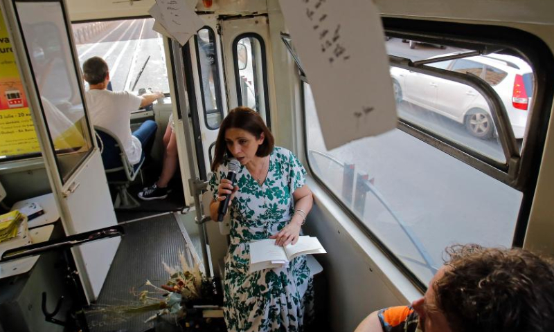 People attend a cultural event called Tramvaiul Bookuresti (Bookarest Tramway) in a vintage tram in Bucharest, capital of Romania, July 23, 2022. Organized by the Cultural Centre of the Townhall, the cultural event is hosted in a vintage tramway where people could listen to poetry, music and historic stories about the town during a two-hour trip.  Photo: Xinhua
