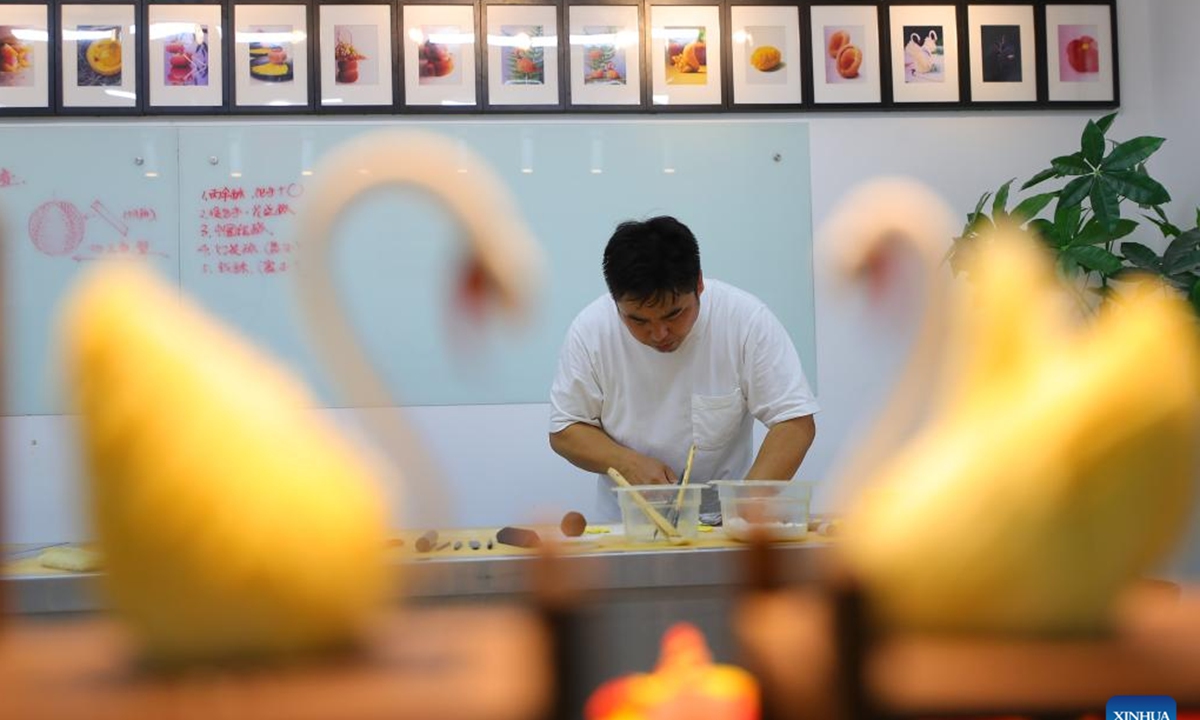 
Chef Wu Yang makes a pastry at his studio in Shenyang, capital of northeast China's Liaoning Province, July 14, 2022. Wu Yang, a 35-year-old chef, has made pastry for ten years. Inspired by traditional Chinese culture, he has created various pastries with vivid shapes at his studio. (Xinhua/Yang Qing)