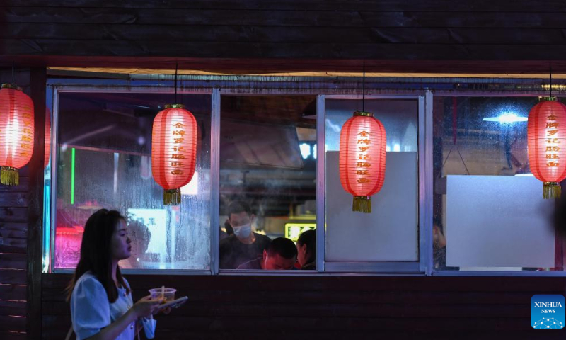 A woman tours a local market at the Qingyun Road in Nanming District of Guiyang, capital city of southwest China's Guizhou Province, July 21, 2022. Photo: Xinhua