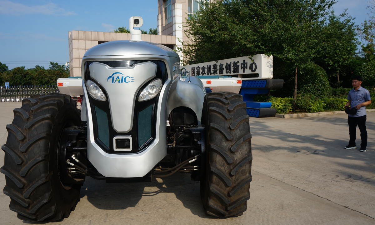 A technician operates a pure electric, smart cabinless tractor via remote control in Luoyang, Central China's Henan Province on July 20, 2022. China produces more than 4,000 models of smart agricultural machines, according to media reports in June. Photo: VCG