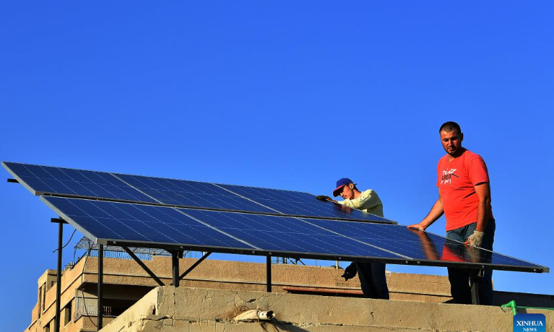 Workers install solar panels atop a building in the Damascus, Syria, July 23, 2022. Solar power systems are becoming more popular in Damascus as a result of the long power cuts. Photo: Xinhua
