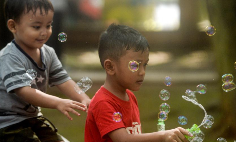 Boys have fun with soap bubbles at the Bumi Serpong Damai City Park in South Tangerang, Banten Province, Indonesia, July 23, 2022. Indonesia commemorates its National Children's Day on July 23 every year. Photo: Xinhua