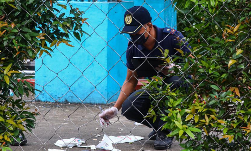 A member of the Philippine National Police inspects the site of a shooting incident at Ateneo de Manila University in Quezon City, the Philippines, July 24, 2022. Three people were killed and two others injured in a shooting incident Sunday afternoon on a university campus in Metro Manila, the Philippine police said. The arrested gunman has admitted to the killing with specific target. Photo: Xinhua