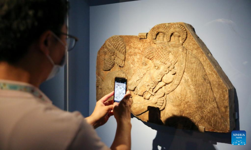 A visitor takes photos of an exhibit at the Mesopotamian Gallery of the National Museum of Korea in Seoul, South Korea, July 21, 2022. (Xinhua/Wang Yiliang)