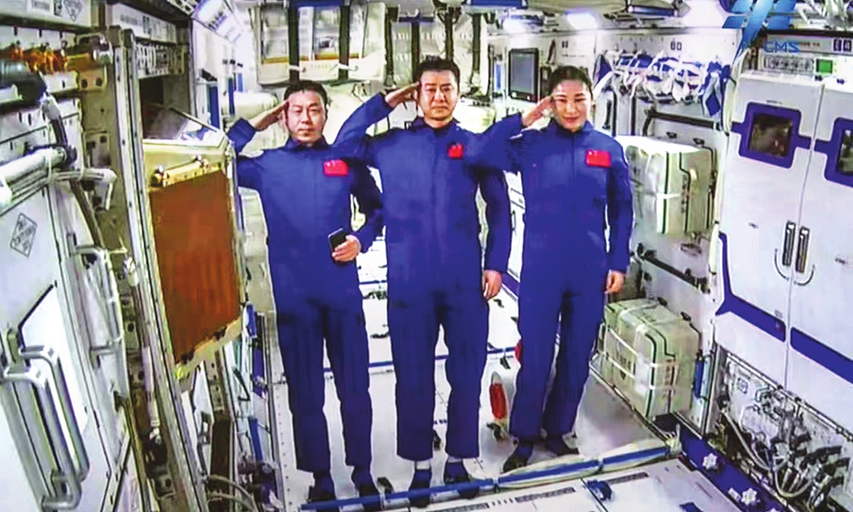 The Shenzhou-14 crew members, Chen Dong (center), Liu Yang (right) and Cai Xuzhe salute from the Wentian (Quest to The Heavens) lab module on July 25, 2022 from some 400 kilometers above the Earth. The three taikonauts checked in to their office and home unit in space at 10:03 am. Photo: cnsphoto