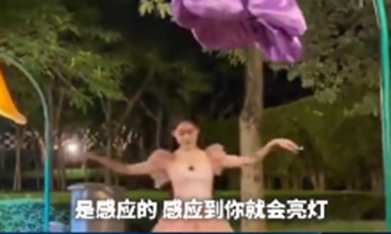 Woman dances with ballet music under flower-shaped streetlamps. Screenshot of The Paper