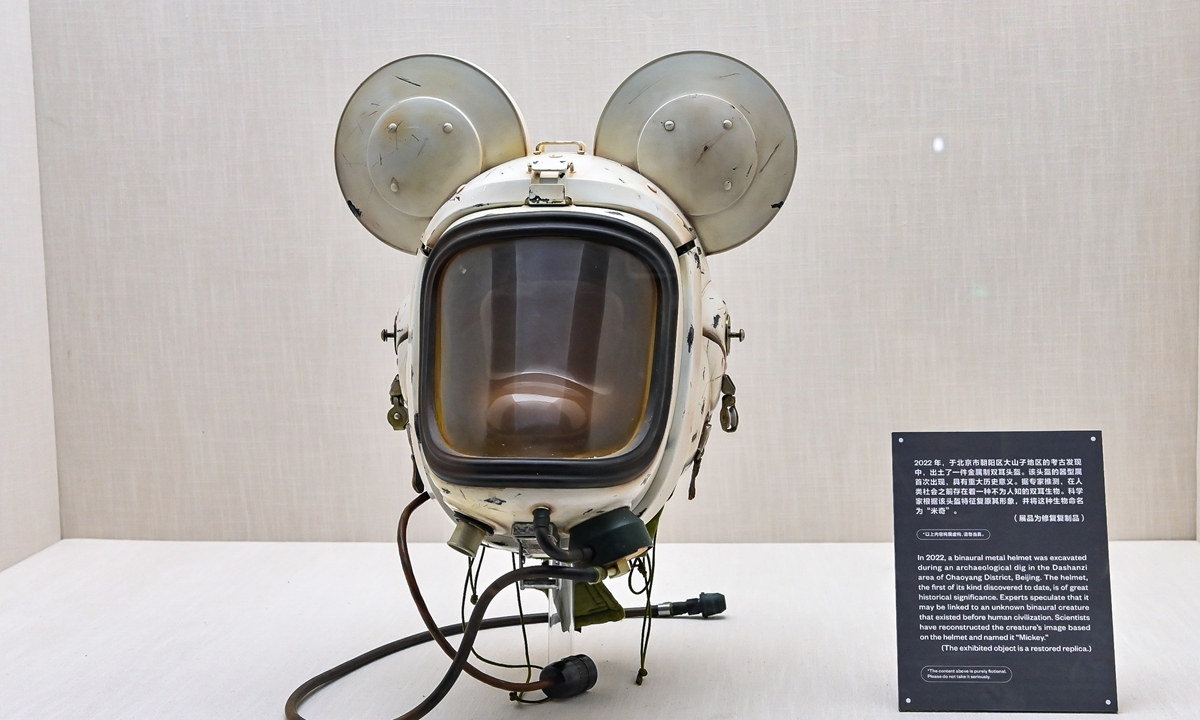Artist Wang Zigeng and his artwork Mickey-shaped space helmet. He aged it to appear as an 