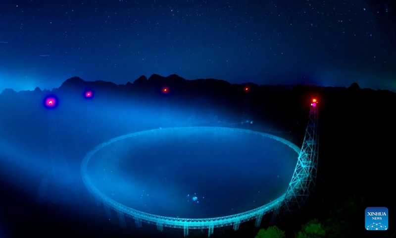 The long-time exposure photo taken on July 24, 2022 shows China's Five-hundred-meter Aperture Spherical Radio Telescope (FAST) under maintenance in southwest China's Guizhou Province. Using FAST, or the China Sky Eye, scientists have identified over 660 new pulsars.(Photo: Xinhua)