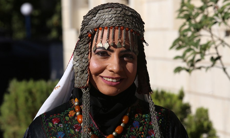 A Palestinian model displays a traditional Palestinian dress during a fashion show celebrating Palestinian Traditional Dress and Heritage Day in the West Bank city of Al-Bireh, on July 25, 2022.(Photo: Xinhua)