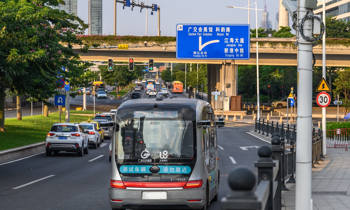 A self-driving bus is tested in the city center of Guangzhou, South China's Guangdong Province on July 26, 2022. Residents can book a free trial ride through their mobile phones. A safety supervisor will be present on each bus equipped with a red emergency brake button, full-directional laser sensors and 360-degree high-definition monitoring cameras. Photo: VCG