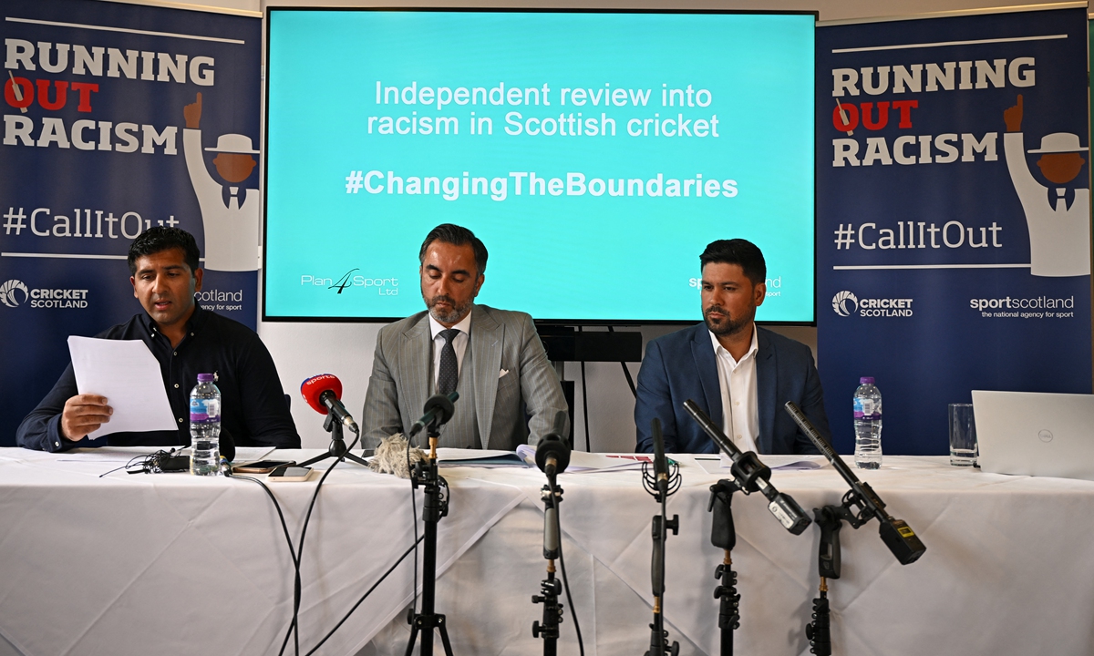 Cricketers Qasim Sheikh (right) and Majid Haq (left) sit with lawyer Aamer Anwar during a press conference at Stirling Court hotel in Stirling, Scotland on July 25, 2022. Photo: AFP