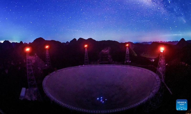 The long-time exposure photo taken on July 24, 2022 shows China's Five-hundred-meter Aperture Spherical Radio Telescope (FAST) under maintenance in southwest China's Guizhou Province. Using FAST, or the China Sky Eye, scientists have identified over 660 new pulsars.(Photo: Xinhua)
