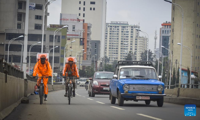 Asnake Nigussie and Melaku Desalegn, bicycle riders working for beU delivery, deliver food in Addis Ababa, Ethiopia, on July 19, 2022.(Photo: Xinhua)