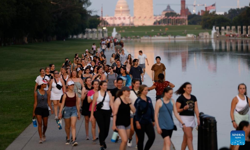 Tourists walk on the National Mall as a heatwave brings temperature to nearly 94 degrees Fahrenheit (34.4 degrees Celsius) in Washington, D.C., the United States, on July 24, 2022. The persistent heatwave from the Southern Plains to the Northeast of the United States has resulted in multiple heat-related deaths as well as disrupted traveling and outdoor events.(Photo: Xinhua)
