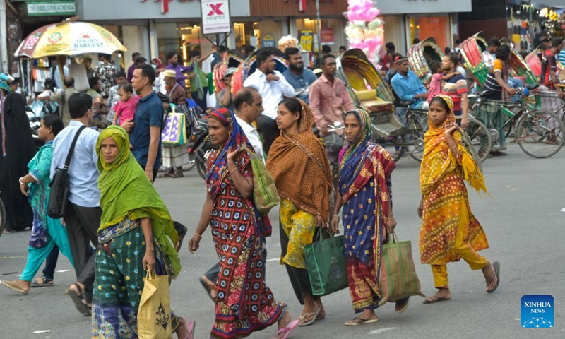 Female workers are seen on a street in Dhaka, Bangladesh, on July 27, 2022.(Photo: Xinhua)