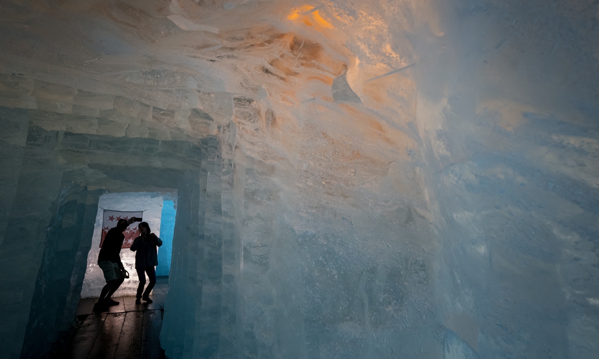 Hikers visit the ice cave of the Rhone Glacier near Gletsch in the Alpine region of Switzerland on July 8, 2022. Photo: AFP