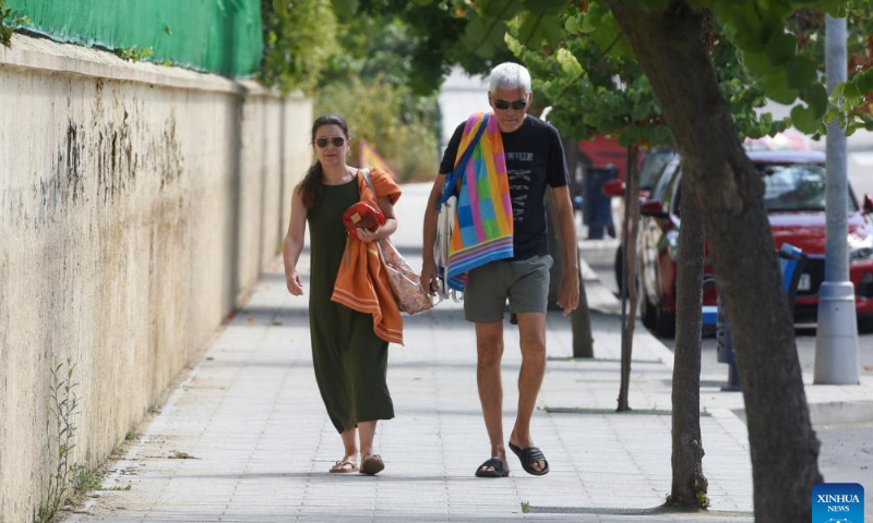 People walk to a swimming pool in Coria, Spain on July 30, 2022. Photo: Xinhua