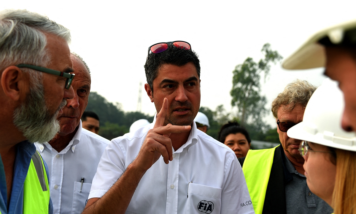 Formula One race director Michael Masi (center) checks on the construction of the Formula One Grand Prix race track in Hanoi, Vietnam on December 13, 2019. Photos: AFP