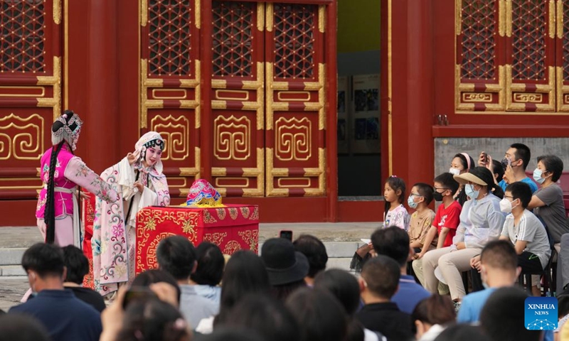 People watch a performance of Kunqu opera at Miaoying Temple, also called Baita Temple, in Beijing, capital of China, July 30, 2022. A series of cultural activities will be held at Miaoying Temple recently.  (Xinhua/Ju Huanzong)