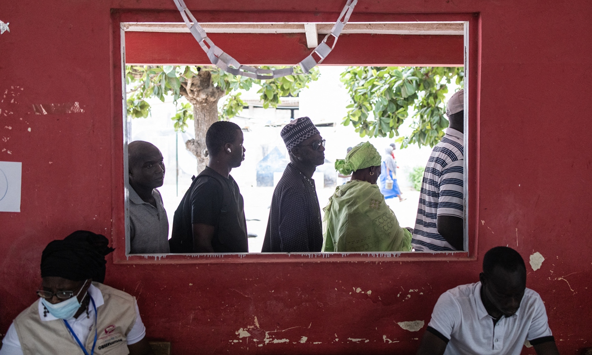 People wait in line outside their voting station in the popular neighborhood of Ngor in Dakar, Senegal on July 31, 2022, as voting starts in Senegal's legislative elections. Photo: AFP
