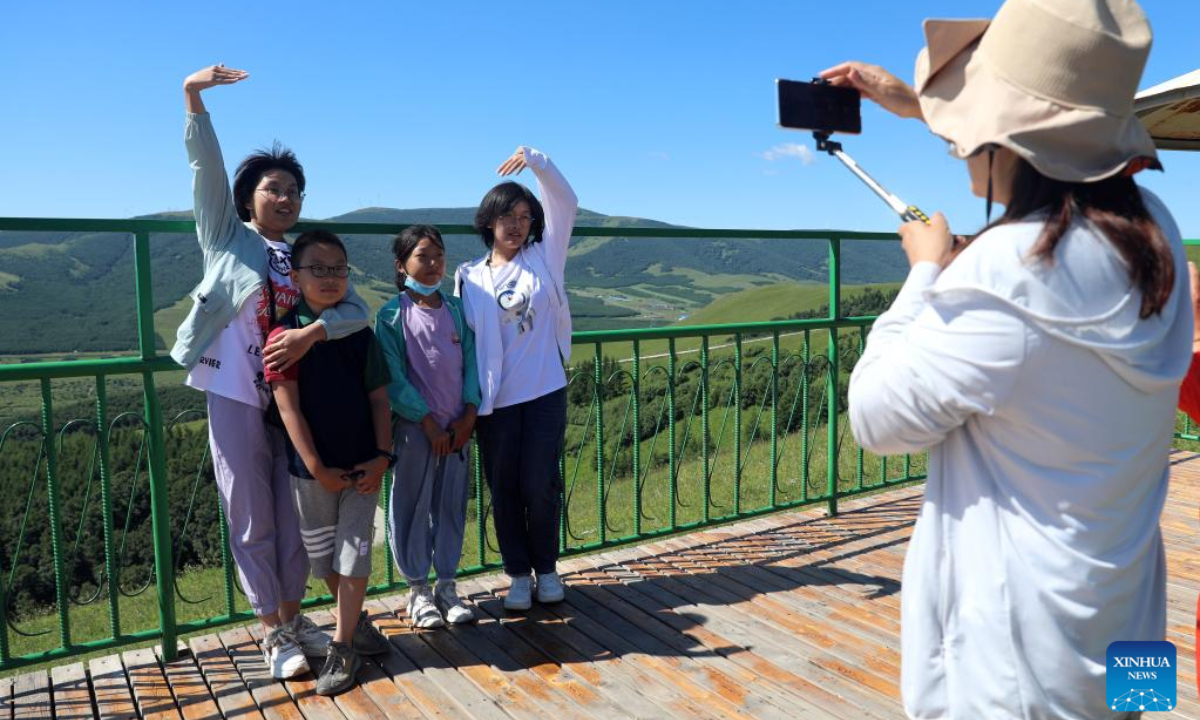 Tourists pose for photos at a forest park in Bashang area of Fengning Manchu Autonomous County, north China's Hebei Province, Aug 5, 2022. Photo:Xinhua