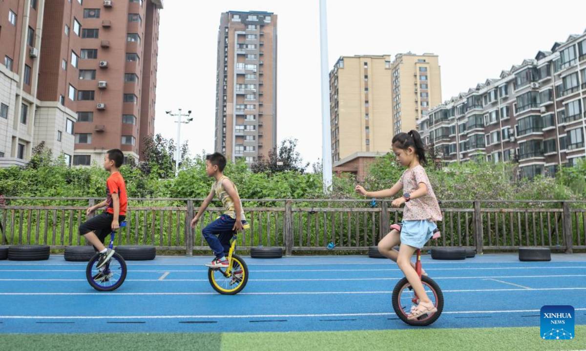 Children practise riding monocycles as part of a summer caring program at a primary school in Shenyang, northeast China's Liaoning Province, Aug 4, 2022. Photo:Xinhua