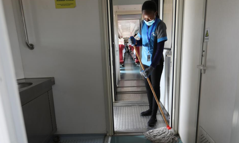 Mercy Gesare cleans the aisle on a Mombasa-Nairobi Railway passenger train, July 29, 2022. Launched on May 31, 2017, the 480 km Mombasa-Nairobi Standard Gauge Railway (SGR), financed mainly by China and constructed by China Road and Bridge Corporation (CRBC), has fostered job creation for local people. Photo: Xinhua