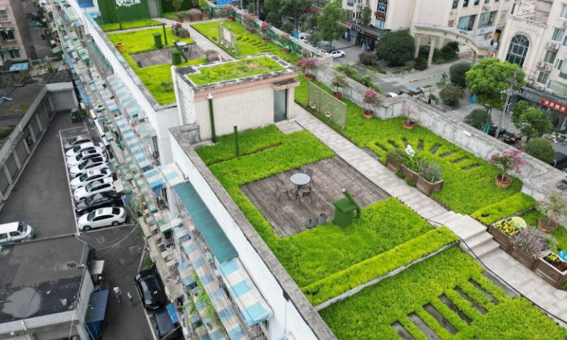 A rooftop garden is built atop an old residential building in Chongqing, Aug. 5, 2022. Residents of 60 households demolished the illegal facilities built on the rooftop and transformed it into a 1,100-square meter shared garden. (Photo: China News Service/Zhang Lang)