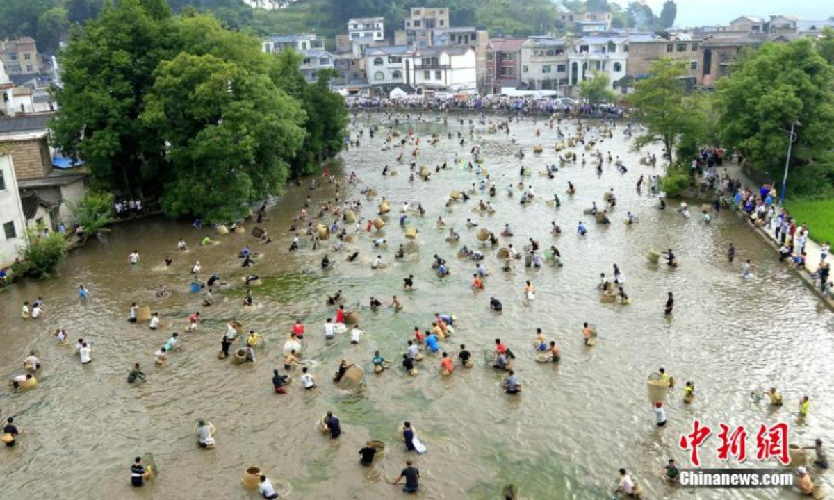 People from the Miao ethnic group catch fish to celebrate the Chixin festival in Shibing county, Qiandongnan Miao and Dong Autonomous Prefecture, southwest China's Guizhou Province, Aug 5, 2022. Chixin festival is a local celebration for good harvest. Photo: China News Service