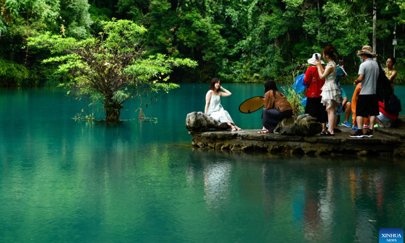 Tourists visit Xiaoqikong scenic spot in Libo County, southwest China's Guizhou Province, Aug. 6, 2022. The county has been promoting tourism consumption under COVID-19 prevention and control measures. Photo: Xinhua