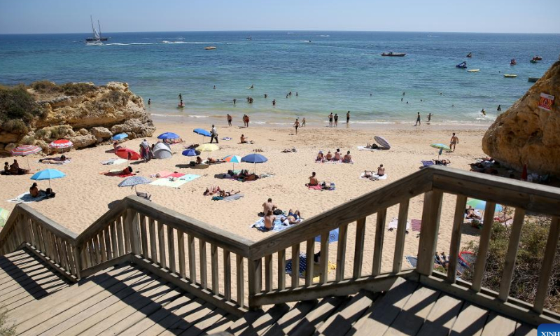Beachgoers sunbathe and swim at Oura beach in Albufeira, Algarve region, Portugal on Aug. 6, 2022. Tourism is rebounding quickly in Portugal.  Photo: Xinhua