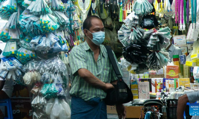 A man wearing a face mask stands in front of a pharmacy in Yangon, Myanmar, on Aug. 6, 2022. Myanmar has recorded no new COVID-19 deaths over the past 122 days, the longest stretch without any fatalities from the virus since the start of the pandemic in the country, the Ministry of Health said on Saturday. Photo: Xinhua