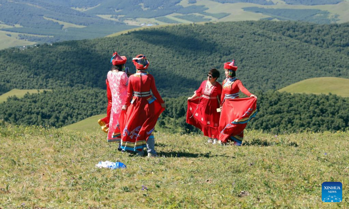 Tourists pose for photos at a forest park in Bashang area of Fengning Manchu Autonomous County, north China's Hebei Province, Aug 5, 2022. Photo:Xinhua