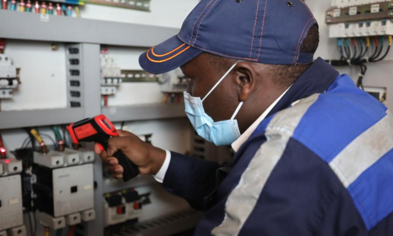Passenger train inspector Cheruiyot Kiptoo Steve checks equipments on a Mombasa-Nairobi Railway passenger train, July 29, 2022. Launched on May 31, 2017, the 480 km Mombasa-Nairobi Standard Gauge Railway (SGR), financed mainly by China and constructed by China Road and Bridge Corporation (CRBC), has fostered job creation for local people. Photo: Xinhua