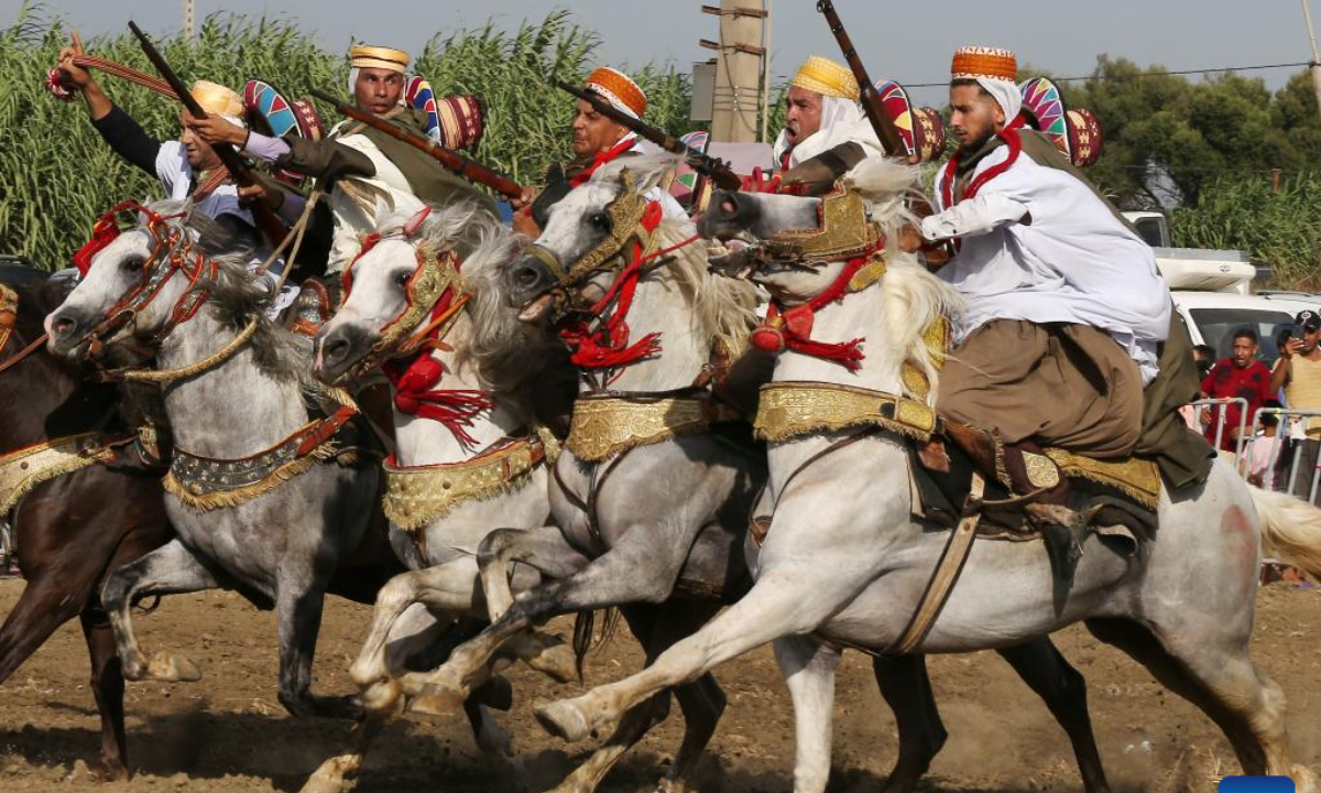 Performers in traditional costumes ride horses during a Fantasia horse show in Algiers, Algeria, on Aug 5, 2022. Fantasia is a traditional exhibition of horsemanship performed during cultural events in northern African region. Photo:Xinhua