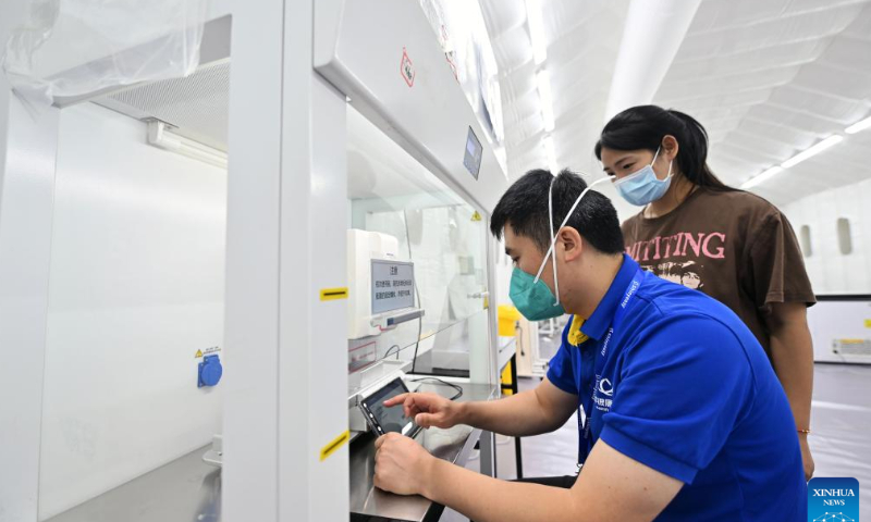 Staff members work in an inflatable COVID-19 testing lab in Sanya, south China's Hainan Province, Aug. 7, 2022. Prevention and control measures have been taken in Sanya to fight against the new resurgence of COVID-19 in the city. Photo: Xinhua