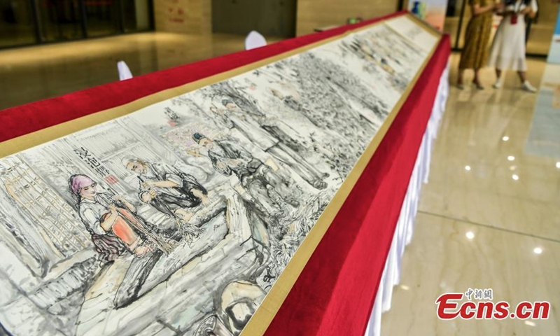 A 16-meter-long painting on mulberry-bark paper is on display during an intangible cultural heritage exhibition in Xinjiang Art Museum, Urumqi, northwest China's Xinjiang Uyghur Autonomous Region, July 31, 2022. (Photo: China News Service/Liu Xin)