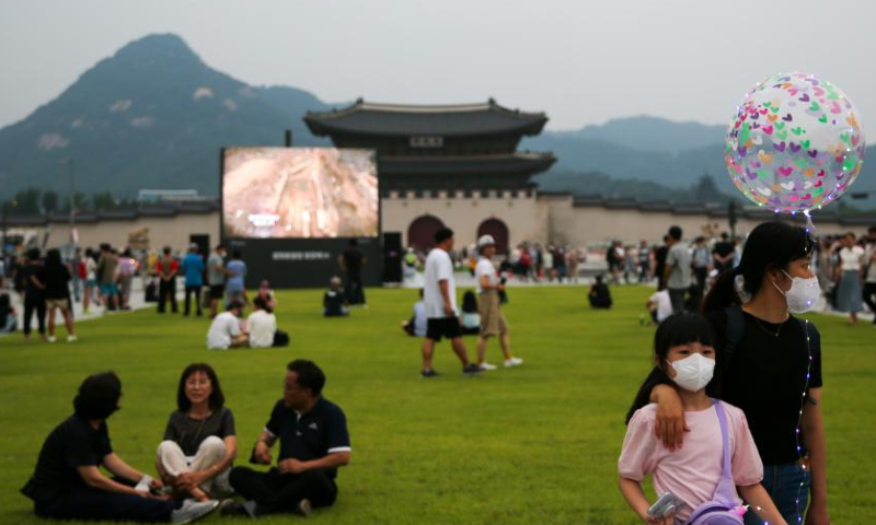Visitors tour and rest on a lawn at the Gwanghwamun Square in Seoul, South Korea, Aug. 6, 2022. Gwanghwamun Square, a major landmark in Seoul, opened to the public Saturday after nearly two years of renovation. Photo: Xinhua
