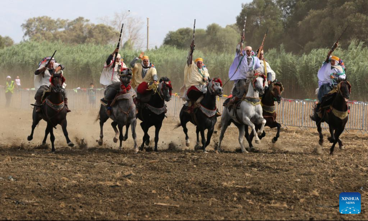 Performers in traditional costumes ride horses during a Fantasia horse show in Algiers, Algeria, on Aug 5, 2022. Fantasia is a traditional exhibition of horsemanship performed during cultural events in northern African region. Photo:Xinhua