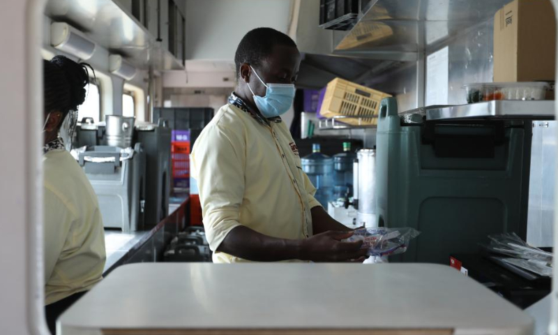 Mark works in the kitchen of a Mombasa-Nairobi Railway passenger train, July 29, 2022. Launched on May 31, 2017, the 480 km Mombasa-Nairobi Standard Gauge Railway (SGR), financed mainly by China and constructed by China Road and Bridge Corporation (CRBC), has fostered job creation for local people. Photo: Xinhua