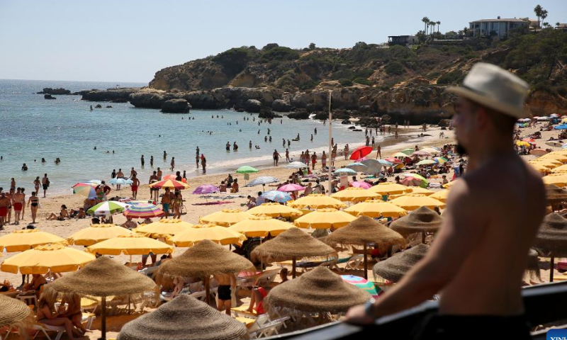 Beachgoers sunbathe and swim at Oura beach in Albufeira, Algarve region, Portugal on Aug. 6, 2022. Tourism is rebounding quickly in Portugal.  Photo: Xinhua