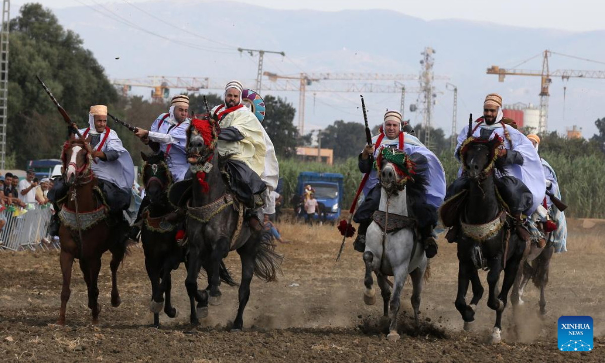 Performers in traditional costumes ride horses during a Fantasia horse show in Algiers, Algeria, on Aug 5, 2022. Fantasia is a traditional exhibition of horsemanship performed during cultural events in northern African region. Photo:Xinhua