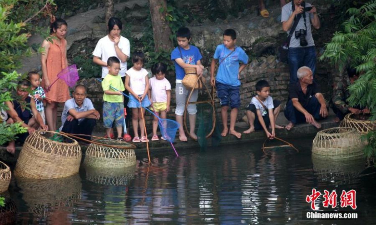 People from the Miao ethnic group catch fish to celebrate the Chixin festival in Shibing county, Qiandongnan Miao and Dong Autonomous Prefecture, southwest China's Guizhou Province, Aug 5, 2022. Chixin festival is a local celebration for good harvest. Photo: China News Service