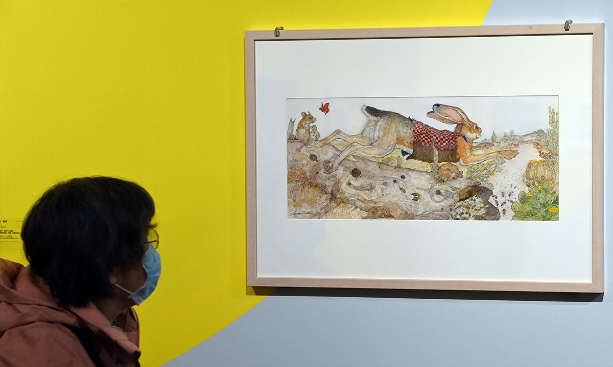 A visitor looks at an illustration by Eric Carle in Beijing. Photo: IC