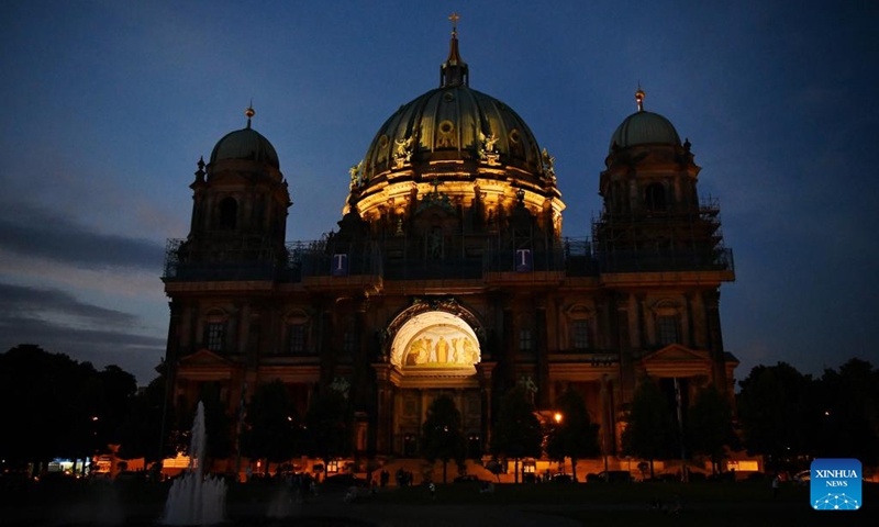 Photo taken on July 29, 2022 shows a night view of the Berlin Cathedral in Berlin, Germany. Some landmark structures across the country have reduced their night illumination to save on electric power. (Xinhua/Ren Pengfei)