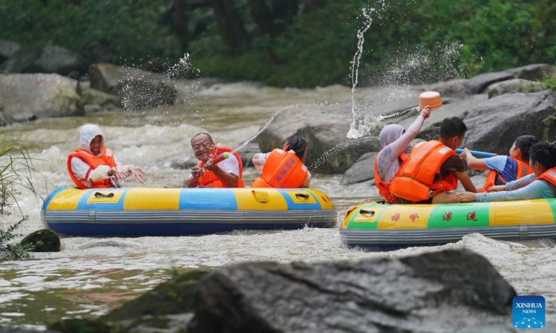People enjoy drifting at a canyon in Meiling scenic spot in Nanchang, capital of east China's Jiangxi Province on Aug. 2, 2022. (Xinhua/Wan Xiang)